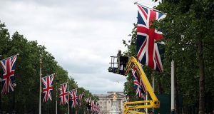 Pictured: Workers line the mall today with Union Flags as the capital makes preparations for the arrival of US President Donald Trump in London